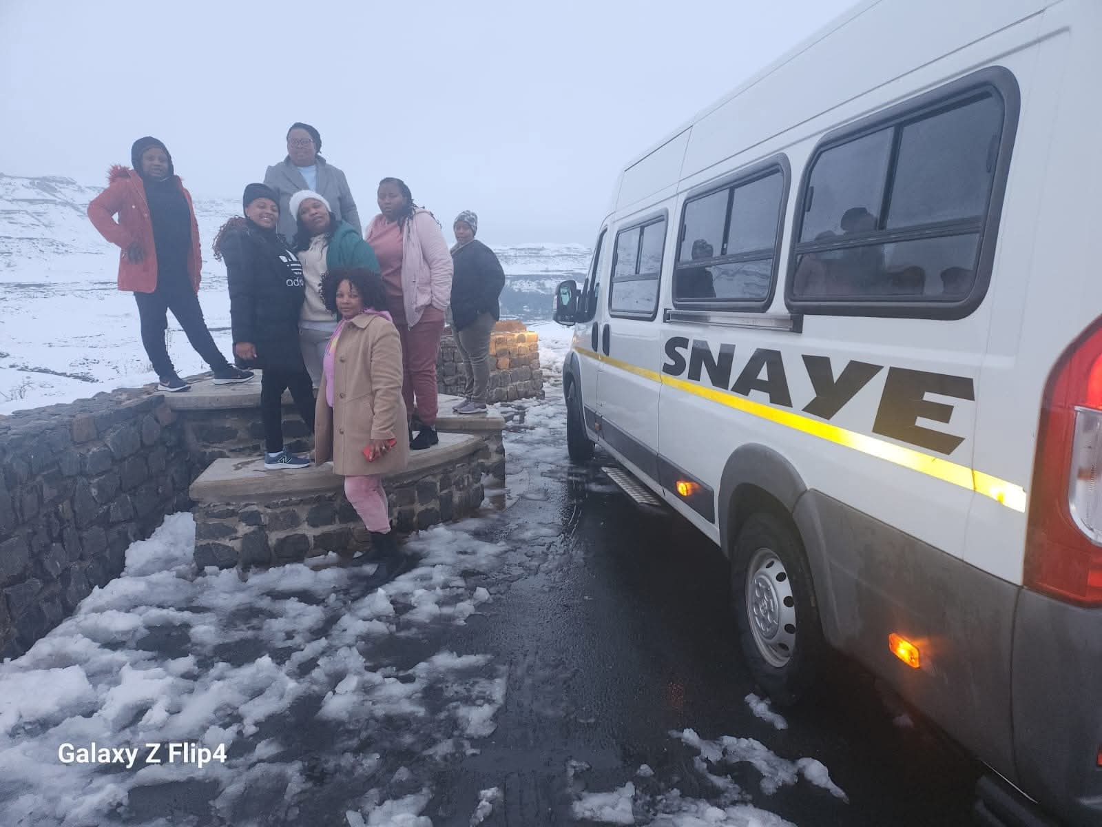 Tour group with Snaye van in snowy Drakensberg mountains